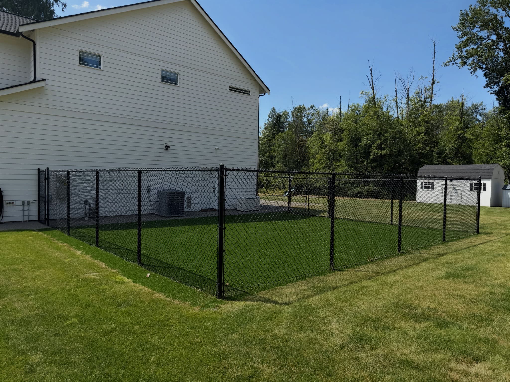 Fully fenced artificial-turf dog run